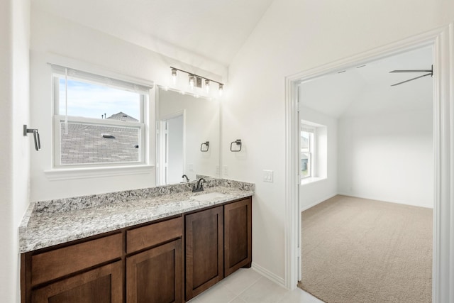 bathroom with ceiling fan, vanity, and vaulted ceiling