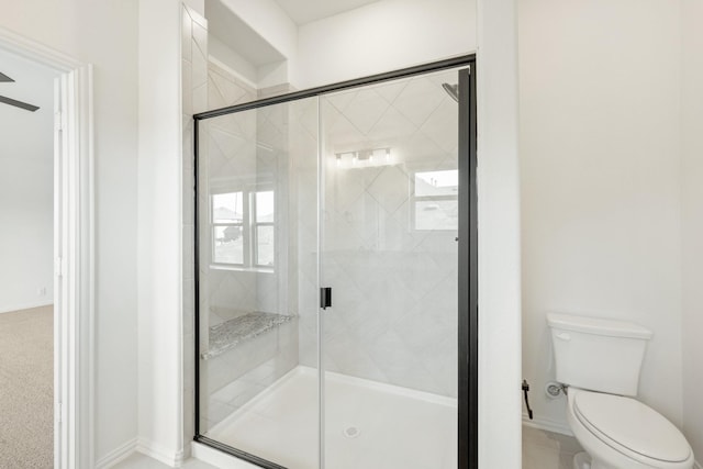 bathroom with an enclosed shower and toilet