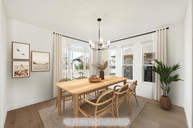 dining room with wood-type flooring and a chandelier