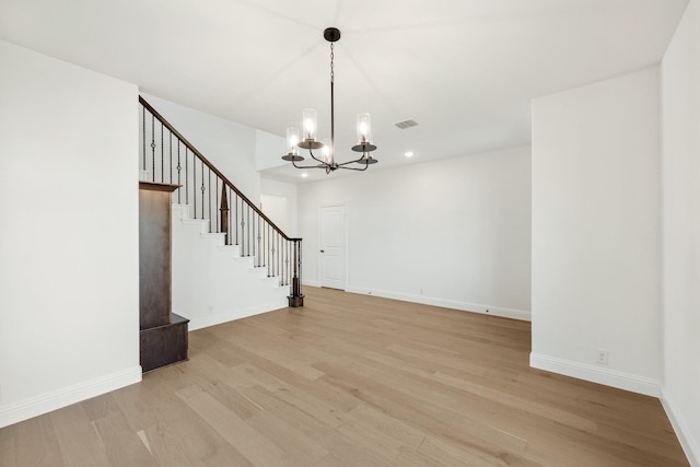 interior space featuring light hardwood / wood-style flooring and a notable chandelier