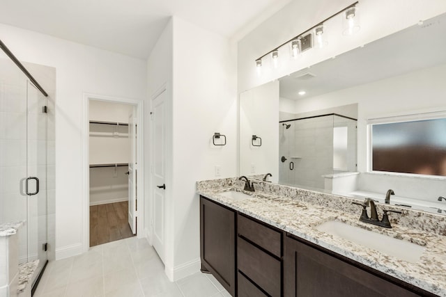 bathroom featuring tile patterned floors, vanity, and an enclosed shower