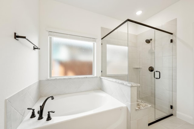 bathroom featuring tile patterned flooring and shower with separate bathtub