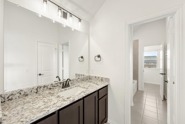 bathroom featuring vanity, tile patterned floors, and lofted ceiling