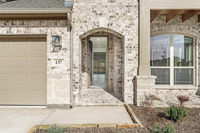 doorway to property with a garage