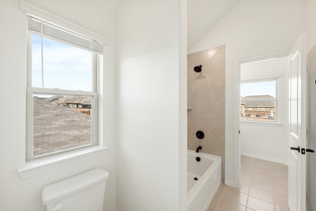 bathroom with tile patterned flooring, a healthy amount of sunlight, lofted ceiling, and toilet