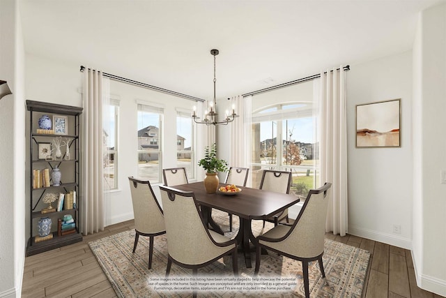 dining area with a chandelier, hardwood / wood-style flooring, and a wealth of natural light