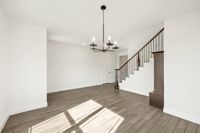 interior space with dark wood-type flooring and an inviting chandelier