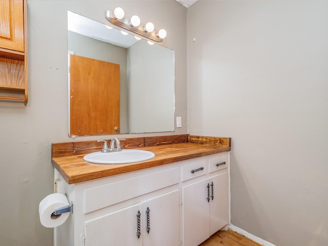 bathroom with hardwood / wood-style flooring and vanity