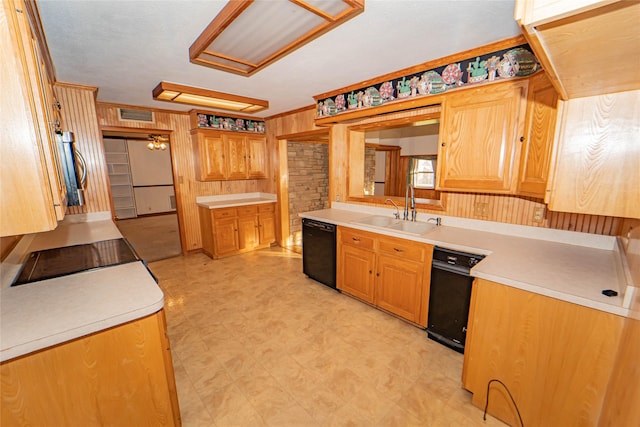 kitchen featuring wooden walls, sink, and black appliances