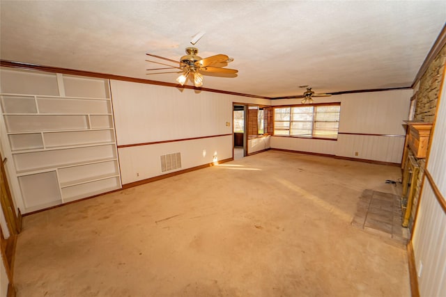 unfurnished living room with crown molding, light colored carpet, ceiling fan, and a textured ceiling