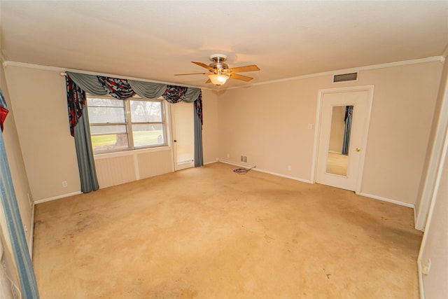 empty room with ceiling fan, ornamental molding, and carpet floors