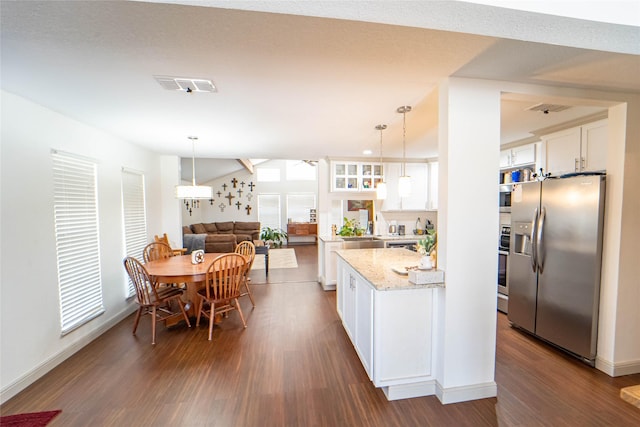 kitchen featuring stainless steel refrigerator with ice dispenser, dark wood-type flooring, white cabinetry, pendant lighting, and light stone countertops