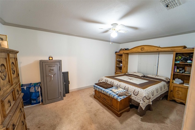 carpeted bedroom with ceiling fan, ornamental molding, and a textured ceiling