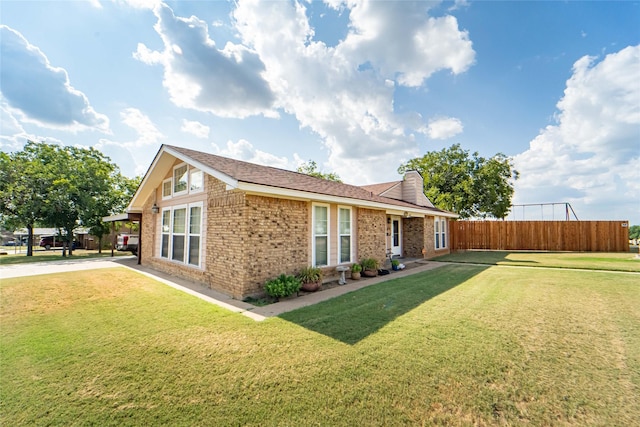 view of side of home with a yard