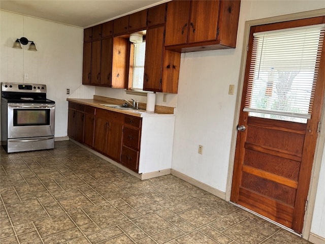 kitchen with plenty of natural light, stainless steel electric stove, and sink