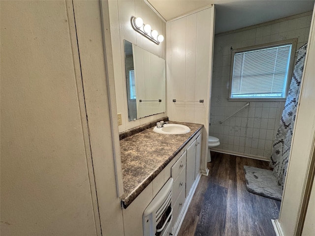 bathroom with hardwood / wood-style flooring, vanity, and toilet