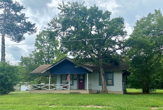 view of front of home with a front yard and covered porch