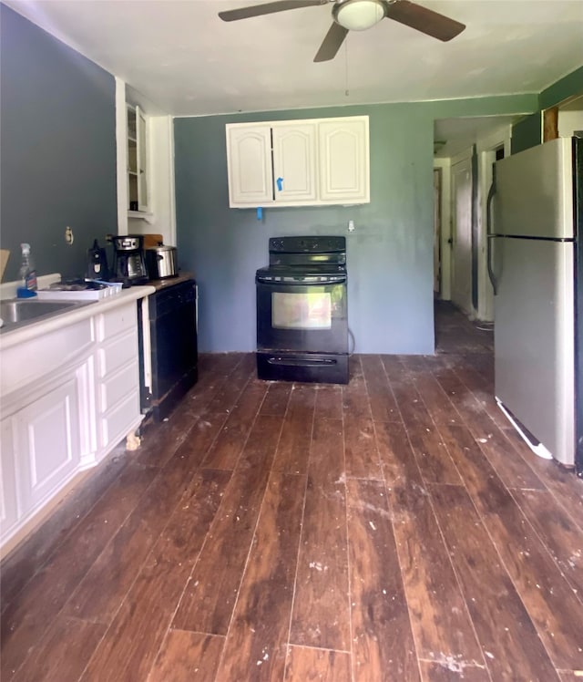 kitchen with white cabinetry, black appliances, ceiling fan, and dark hardwood / wood-style floors