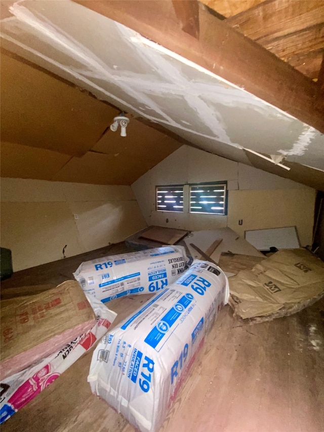 unfurnished bedroom featuring wood-type flooring and vaulted ceiling