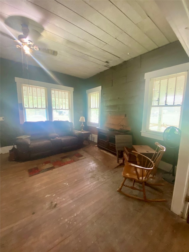 living area with ceiling fan and hardwood / wood-style flooring