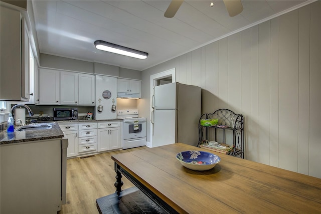 kitchen featuring sink, ornamental molding, white appliances, dark stone counters, and white cabinets