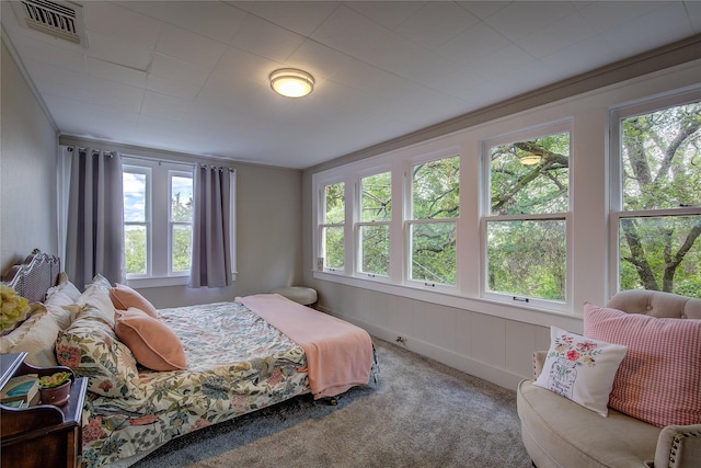 bedroom with crown molding and carpet floors