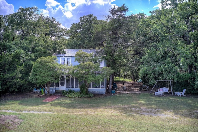 view of front of house featuring a front lawn and a sunroom