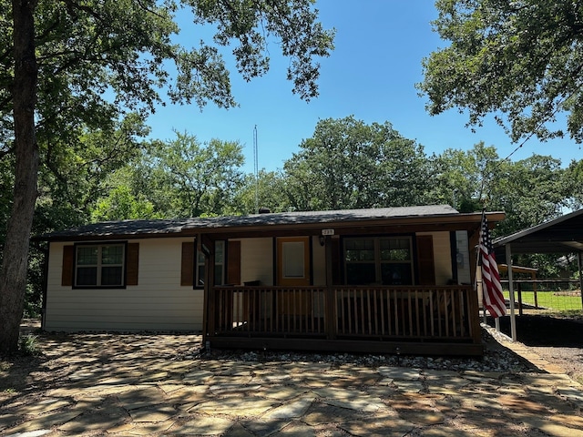 single story home with a carport and covered porch