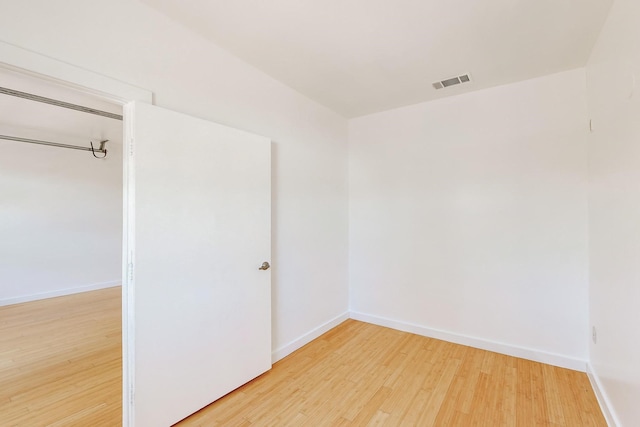 unfurnished room with light wood-type flooring