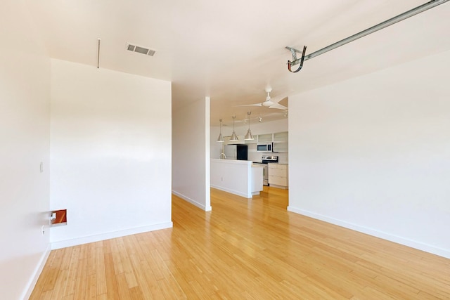 unfurnished living room featuring light hardwood / wood-style flooring and ceiling fan