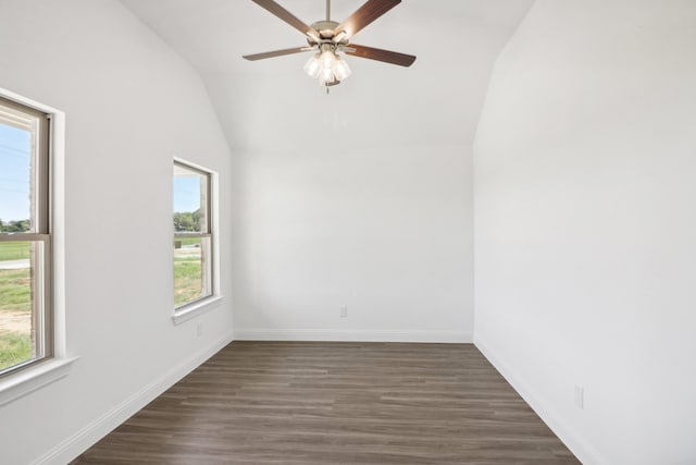 unfurnished room featuring lofted ceiling, ceiling fan, dark hardwood / wood-style floors, and plenty of natural light