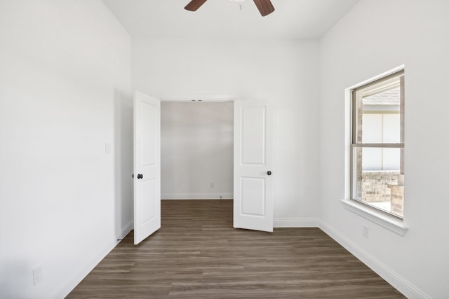 unfurnished bedroom featuring dark hardwood / wood-style flooring and ceiling fan