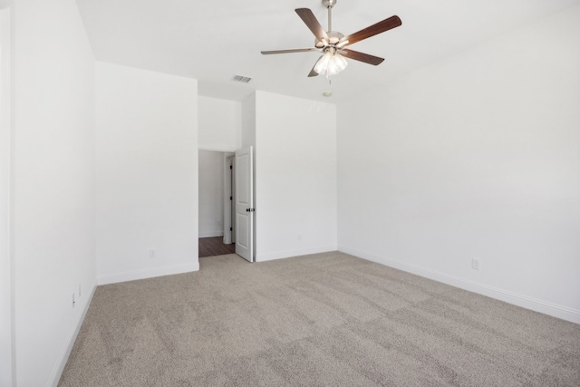 carpeted spare room featuring ceiling fan