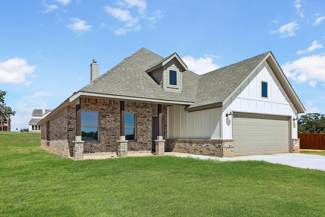 view of front of property featuring a garage and a front lawn