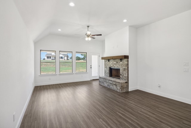 unfurnished living room featuring ceiling fan, vaulted ceiling, a fireplace, and dark hardwood / wood-style flooring