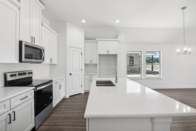 kitchen with dark wood-type flooring, a kitchen island with sink, sink, white cabinetry, and stainless steel appliances