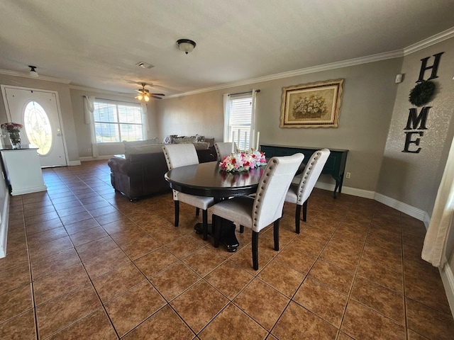 tiled dining area featuring ornamental molding and ceiling fan