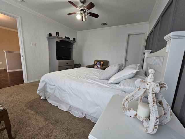 carpeted bedroom featuring crown molding, visible vents, a textured wall, a ceiling fan, and a textured ceiling