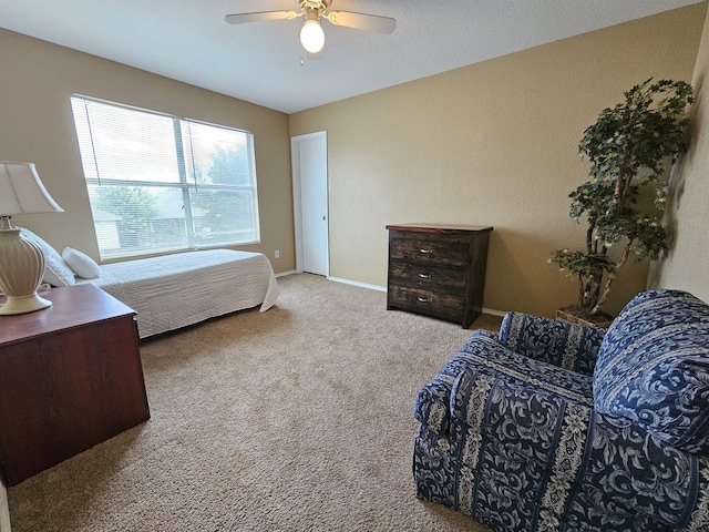 carpeted bedroom featuring ceiling fan and baseboards