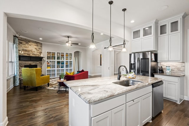 kitchen featuring sink, stainless steel appliances, dark hardwood / wood-style floors, an island with sink, and white cabinets