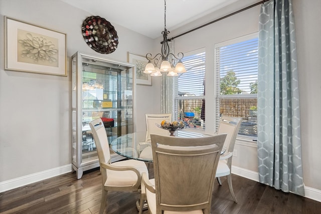 dining room featuring dark hardwood / wood-style flooring and a notable chandelier