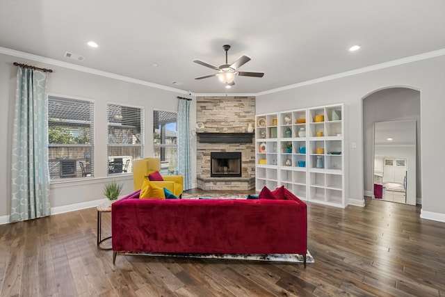 living room featuring a fireplace, dark hardwood / wood-style flooring, ceiling fan, and ornamental molding