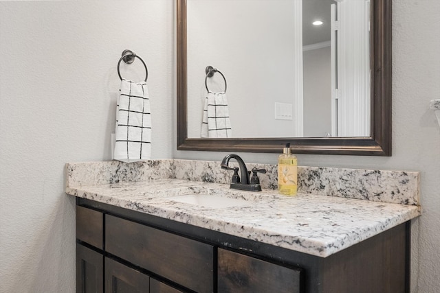 bathroom featuring vanity and ornamental molding