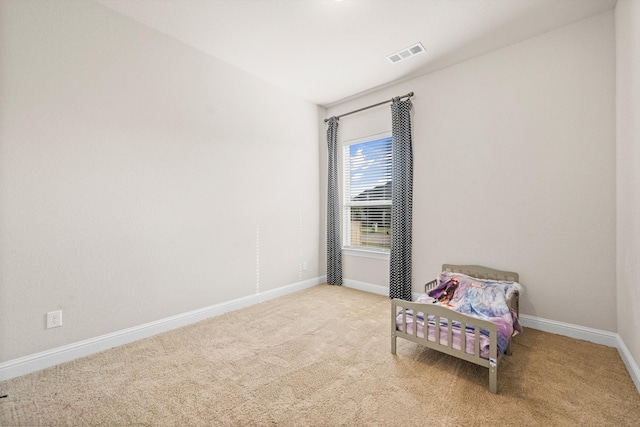 living area featuring light carpet