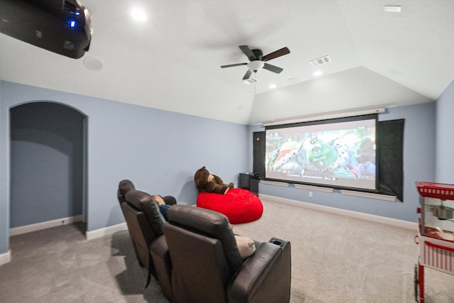 carpeted home theater room featuring vaulted ceiling and ceiling fan