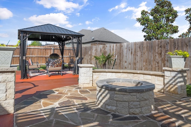 view of patio with a gazebo and a fire pit