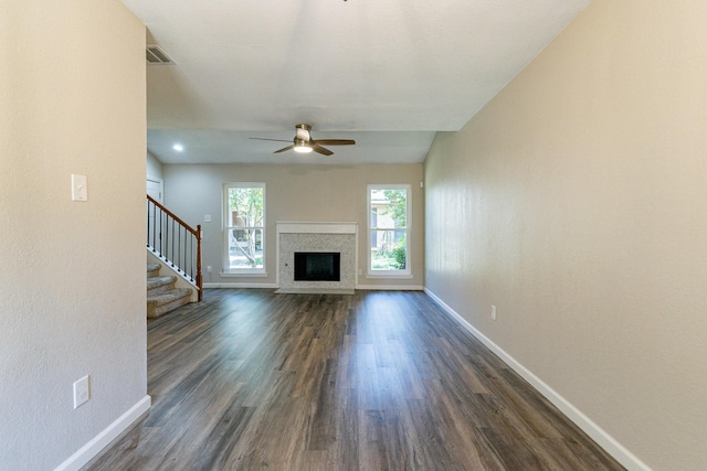 unfurnished living room featuring dark hardwood / wood-style floors and ceiling fan