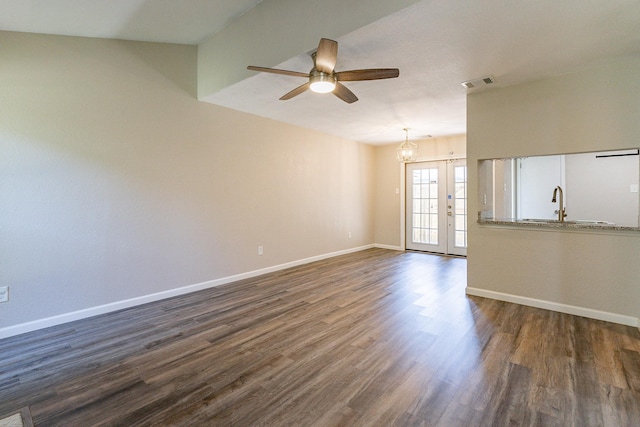 unfurnished living room featuring ceiling fan, sink, dark hardwood / wood-style flooring, and french doors