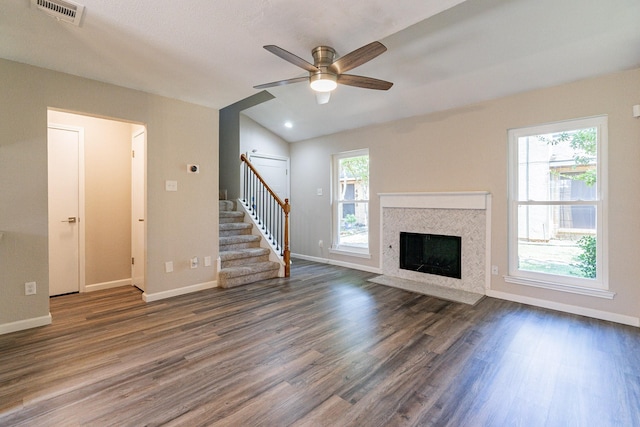 unfurnished living room with ceiling fan, dark hardwood / wood-style floors, and vaulted ceiling