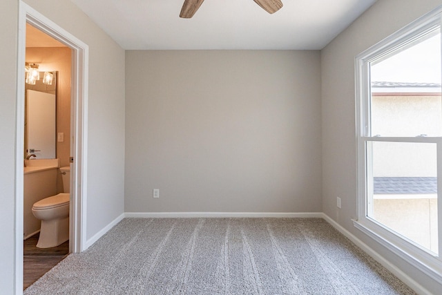 spare room featuring carpet floors and ceiling fan